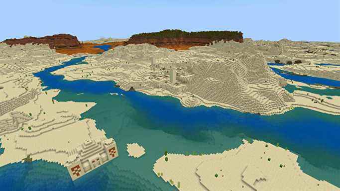 Un paysage Minecraft Bedrock avec désert et rivière au premier plan et badlands au loin.