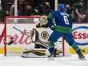 L'attaquant des Canucks de Vancouver Brock Boeser (6) marque sur le gardien des Bruins de Boston Jeremy Swayman (1) en deuxième période au Rogers Arena.