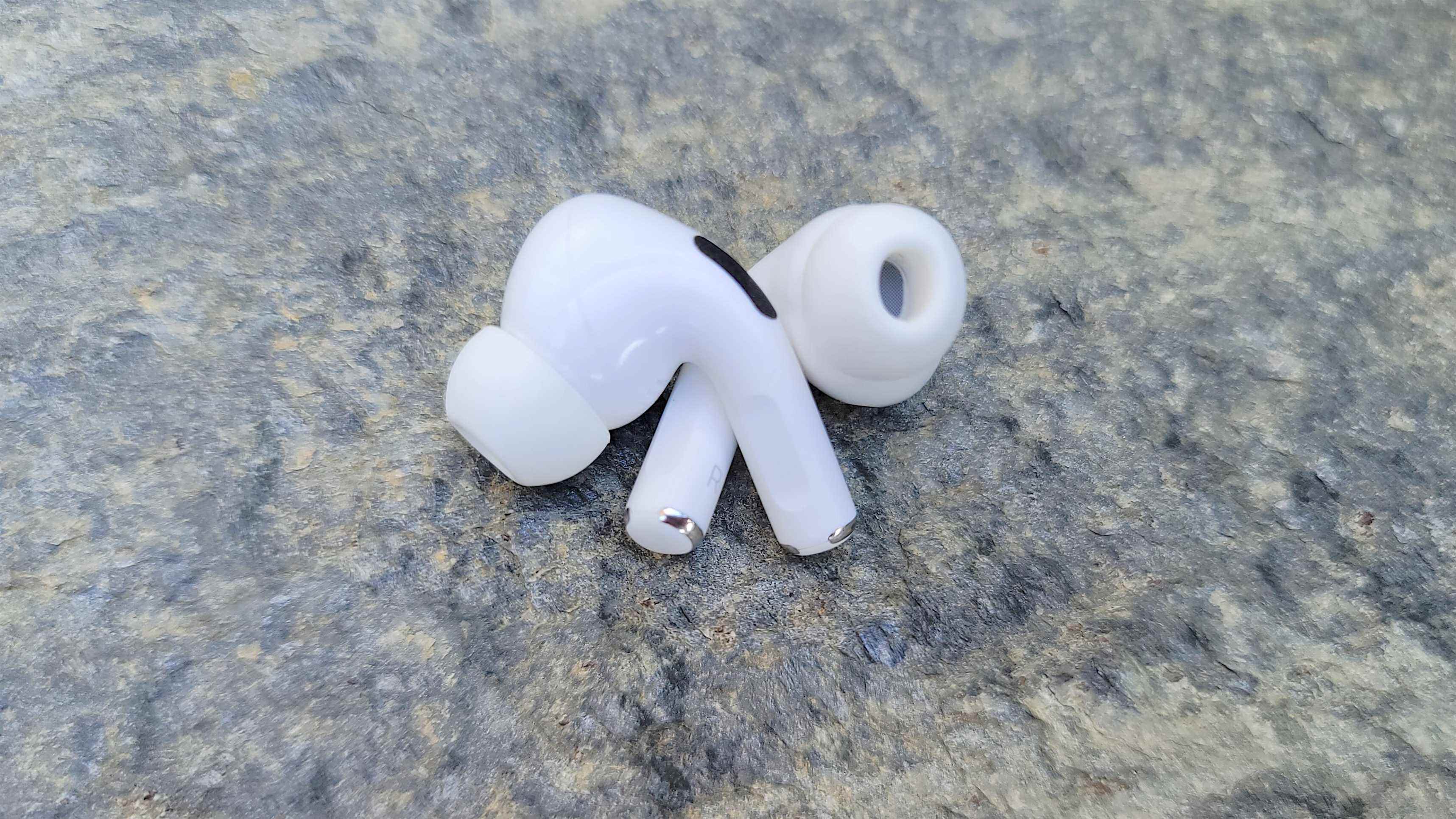 Les AirPods 3 posés sur une surface en béton