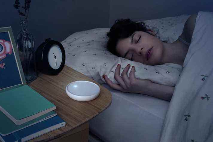 Dodow aide au sommeil sur la table de nuit dans l'obscurité.