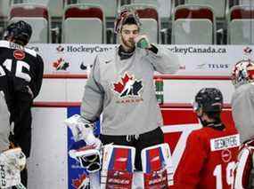 Le gardien Sebastian Cossa fait une pause pour une pause aquatique lors d'un entraînement au camp de sélection des Championnats canadiens de hockey junior à Calgary, le jeudi 9 décembre 2021. LA PRESSE CANADIENNE/Jeff McIntosh ORG XMIT : JMC108_2021121000