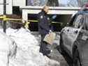 Un agent de police de Toronto apporte un sac de preuves dans le parking souterrain du 72, avenue Gamble, le jeudi 20 janvier 2022, le lendemain de la mort par balle de Jordon Carter, 15 ans.  