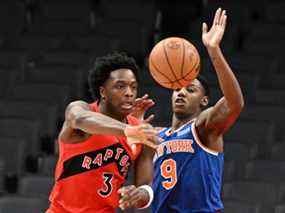 OG Anunoby des Raptors passe le ballon loin de RJ Barrett des New York Knicks au cours de la première mi-temps à la Scotiabank Arena le dimanche 2 janvier 2022.