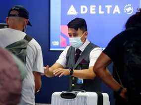 Un employé de Delta Air Lines travaille au niveau des départs à l'aéroport international de Los Angeles (LAX) le 25 août 2021 à Los Angeles, Californie.  (Photo de Mario Tama/Getty Images)