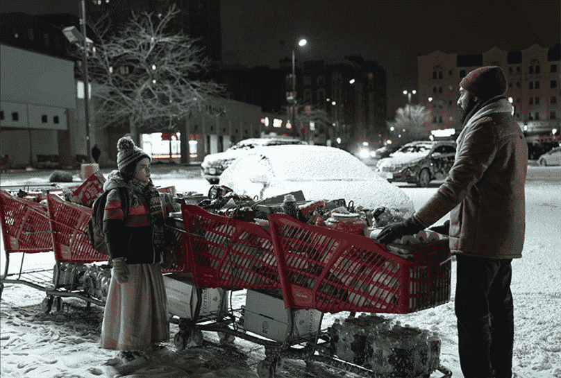 Station-Eleven-HBO-Series-Still-Girl-and-Man-Standing-With-Grocery-Carts