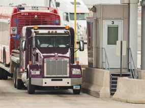 Un camionneur attend au kiosque des douanes canadiennes et à la frontière canado-américaine à Sarnia, en Ontario, le 16 mars 2020.