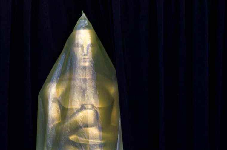 Covered in plastic, an Oscar statue