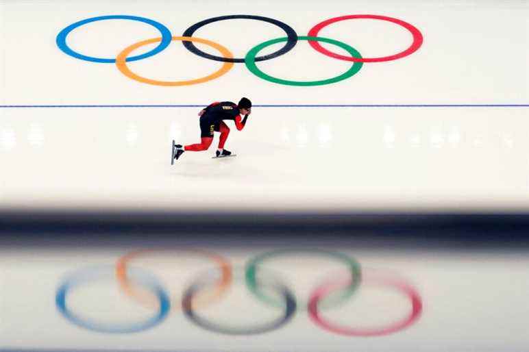 A Chinese athlete warms up before the start of the men's speedskating 1,500-meter race at the 2022 Winter Olympics, Tuesday, Feb. 8, 2022, in Beijing. (AP Photo/Ashley Landis)