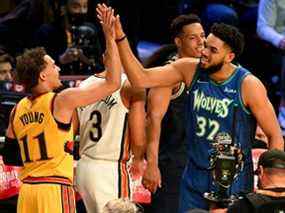 Karl-Anthony Towns des Minnesota Timberwolves célèbre avec Trae Young des Atlanta Hawks au Rocket Mortgage Fieldhouse le 19 février 2022 à Cleveland, Ohio.