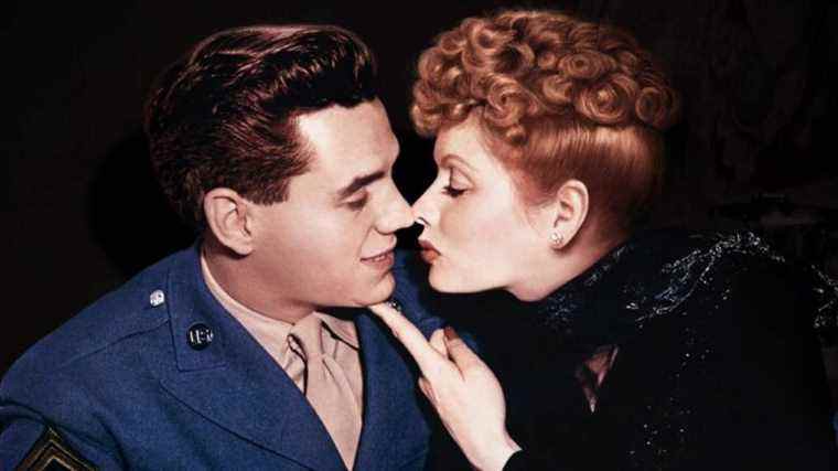 Lucille Ball puts a finger under the chin of Desi Arnaz, in color