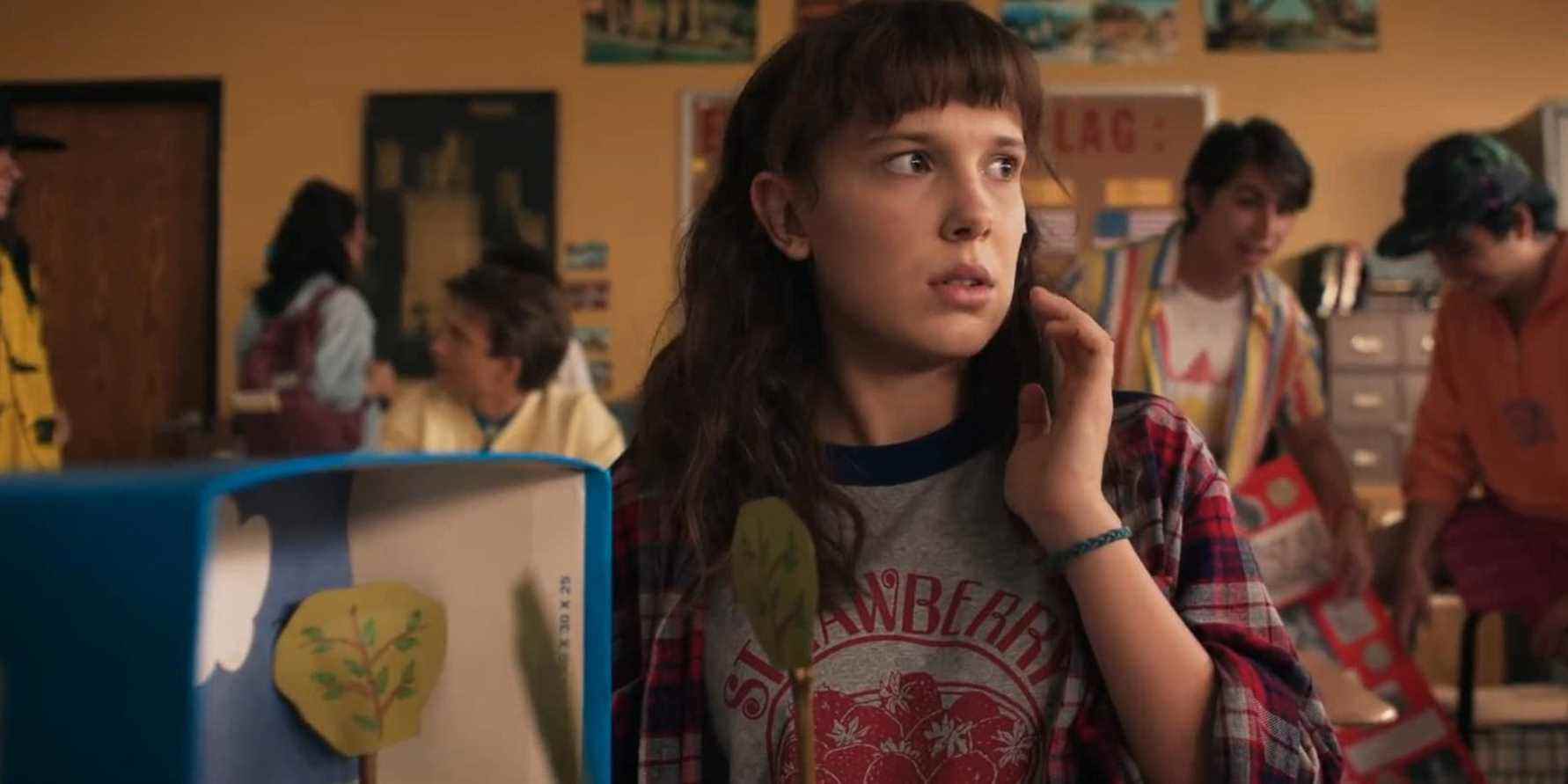 Millie Bobby Brown as Eleven talking on the phone in Stranger Things