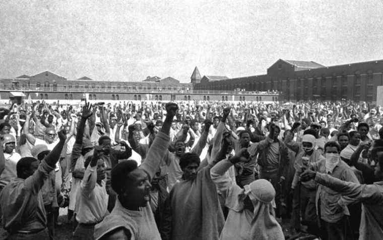 FILE - This Sept. 10, 1971 file photo shows inmates of Attica State Prison as they raise their hands in clenched fist salutes to voice their demands during a negotiating session with New York's prison Commissioner Russell Oswald. The whistleblower who spurred a major state investigation of alleged crimes and cover-ups at Attica prison is still on the case four decades later. Ex-prosecutor Malcolm Bell, now 82 and retired to the Green Mountains of Vermont, recently filed court papers in support of opening long-sealed investigation volumes. (AP Photo, File)