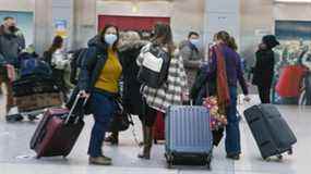 Voyageurs à l'aéroport international Pearson le 11 mars 2022. Même si plusieurs provinces ont abandonné les mandats de masque intérieur, la mesure reste en place dans les aéroports et les terminaux ferroviaires, qui sont sous réglementation fédérale.