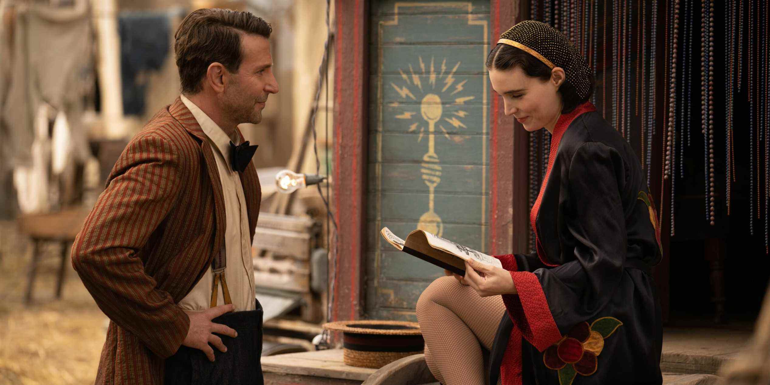 Stan (Bradley Cooper) talks to Molly (Rooney Mara) at her tent in Nightmare Alley