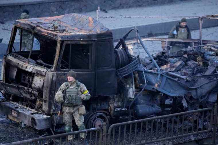 Ukrainian troops inspect the site following a Russian airstrike in Kyiv, Ukraine, Saturday, Feb. 26, 2022. (AP Photo/Vadim Ghirda)