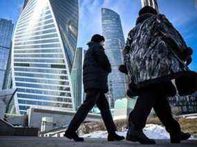 Des femmes marchent devant le complexe du Centre d'affaires international de Moscou (Moskva City) à Moscou.  Les entreprises et les ménages sont confrontés à une récession économique à deux chiffres et à une inflation qui s'accélère vers 20 %.