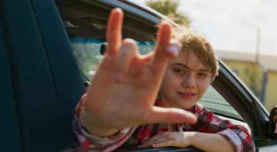 Ruby gives the love sign out the car window in CODA