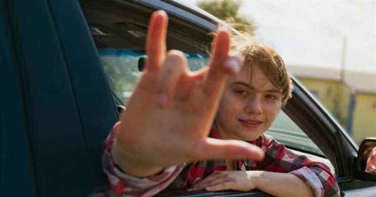 Ruby gives the love sign out the car window in CODA