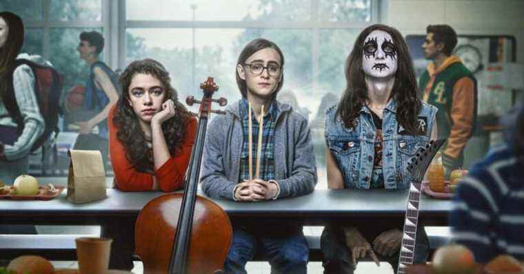 The three young friends of Metal Lords sit at a lunch table