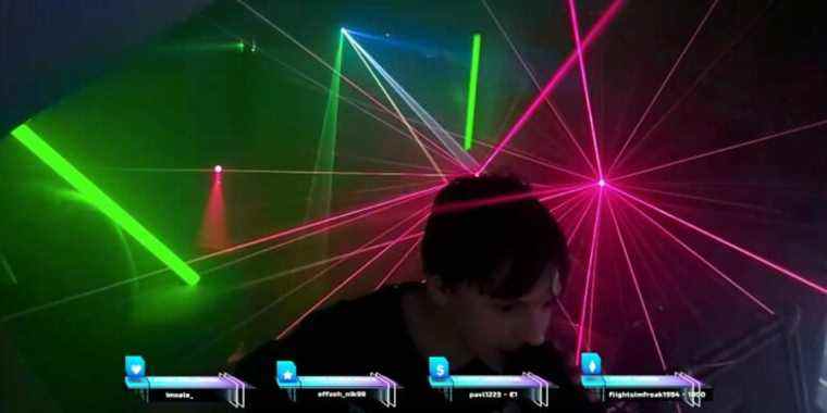 teenager crossmauz leans into his mic as lasers go off behind him