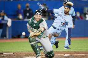 Lourdes Gurriel Jr. des Blue Jays marque un coup sûr de Matt Chapman alors que Stephen Vogt des Oakland Athletics rate la prise à domicile lors de la cinquième manche au Rogers Centre le dimanche 17 avril 2022 à Toronto.  COLE BURSTON/GETTY IMAGES