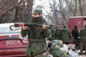 Des militaires des troupes pro-russes se rassemblent dans une rue pendant le conflit Ukraine-Russie dans la ville portuaire méridionale de Marioupol, Ukraine, le 17 avril 2022.