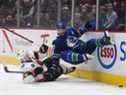 Connor Brown, des Sénateurs d'Ottawa, à gauche, et Oliver Ekman-Larsson des Canucks de Vancouver s'affrontent lors de la première période d'un match de hockey de la LNH à Vancouver, en Colombie-Britannique, le mardi 19 avril 2022.