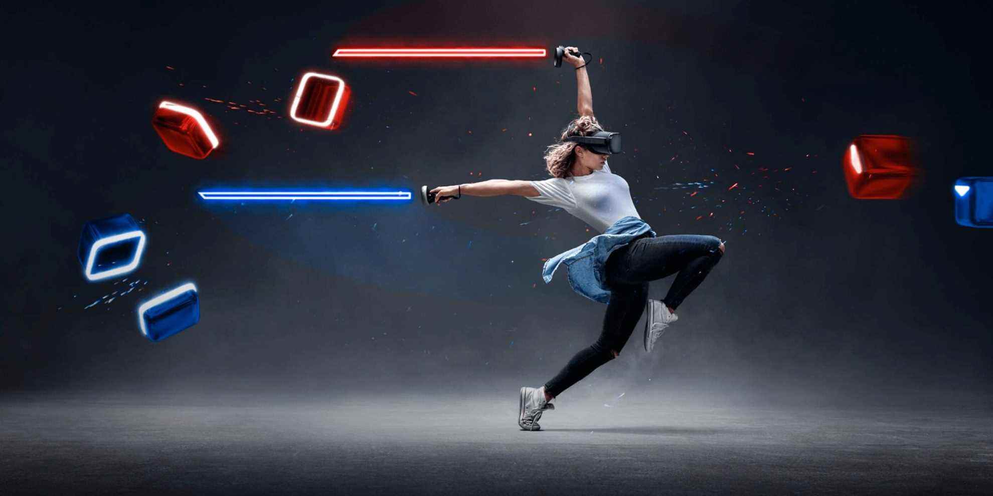 A woman in white t-shirt and sneakers wearing a VR headset leaps towards approaching red and blue blocks, her arms stretched behind her holding two lightsabesr