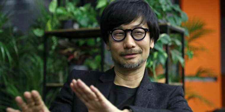 Photo of Hideo Kojima with plants in the background.