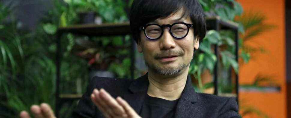 Photo of Hideo Kojima with plants in the background.