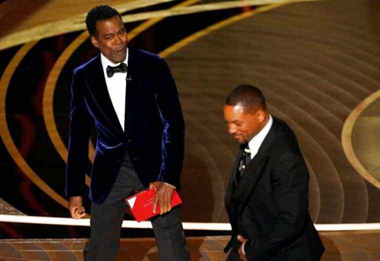 Presenter Chris Rock, left, reacts after Will Smith slapped him onstage during the 94th Academy Awards at the Dolby Theatre, Sunday, March 27, 2022, in Los Angeles. (AP Photo/Chris Pizzello)