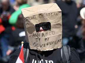 Un supporter porte un sac en papier lors d'un rassemblement sur la Colline du Parlement lors du Rolling Thunder Convoy le 30 avril 2022 à Ottawa, Canada.