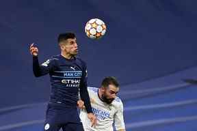 Le défenseur portugais de Manchester City, Joao Cancelo (L), rivalise avec le défenseur espagnol du Real Madrid, Dani Carvajal, lors du match de football de deuxième jambe de la demi-finale de la Ligue des champions de l'UEFA entre le Real Madrid CF et Manchester City au stade Santiago Bernabeu de Madrid le 4 mai 2022. ( Photo PIERRE-PHILIPPE MARCOU / AFP)