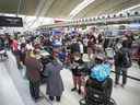 Des voyageurs font la queue au terminal 1 de l'aéroport Pearson de Toronto, le 9 mai 2022.