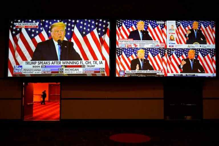 A live broadcast of President Donald Trump speaking from the White House is shown on screens at an election night party, Tuesday, Nov. 3, 2020, in Las Vegas. (AP Photo/John Locher)