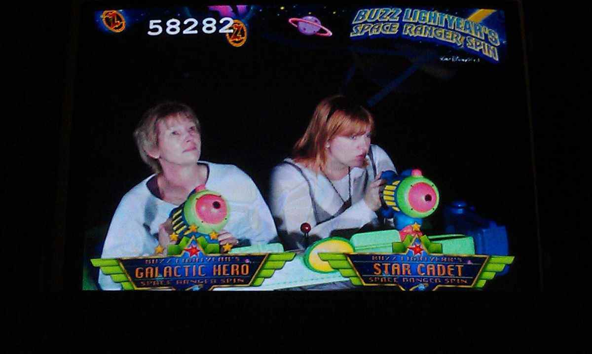 deux personnages sur le trajet buzz lightyear, la femme plus âgée lève les yeux vers les étoiles, clairement inspirée ;  la jeune femme est concentrée