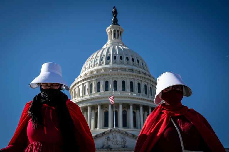 Abortion rights activists costumed after Margaret Atwood's "The Handmaid's Tale" protest outside the U.S. Capitol in Washington, D.C. on Nov. 27, 2021. The Supreme Court will hear arguments on Dec. 1 in a Mississippi bid to have the landmark Roe v. Wade decision overturned, sparking outcry from women's advocacy groups. (Photo by Alejandro Alvarez/Sipa USA)(Sipa via AP Images)