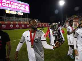 L'attaquant du Toronto FC Ayo Akinola marche avec la Coupe des Voyageurs après avoir battu le Forge FC au Tim Hortons Field.