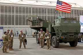 Dans cette photo d'archive prise le 6 mars 2022, des militaires américains se tiennent à côté d'un système de roquettes d'artillerie à haute mobilité M142 (HIMARS) lors du premier World Defence Show d'Arabie saoudite, au nord de la capitale Riyad.