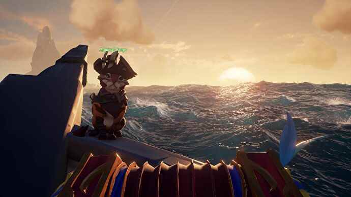 Un adorable chat assis sur la proue d'un bateau dans Sea Of Thieves