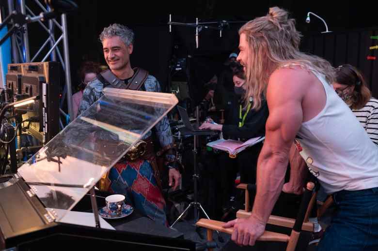 (L-R): Director Taika Waititi as Korg and Chris Hemsworth as Thor on the set of Marvel Studios' THOR: LOVE AND THUNDER. Photo by Jasin Boland. ©Marvel Studios 2022. All Rights Reserved.