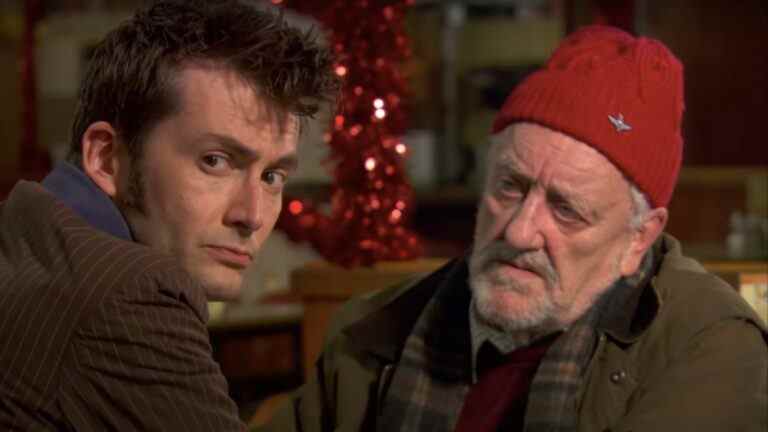 David Tennant sitting somberly with Bernard Cribbins in a cafe in Doctor Who.