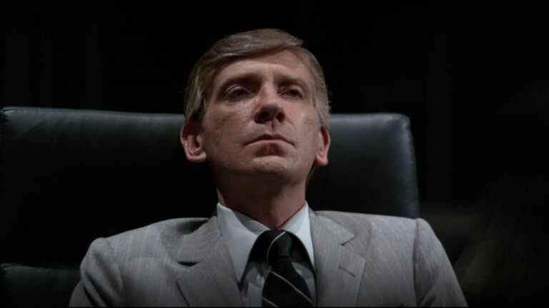 David Warner sits in his office looking annoyed in Tron.