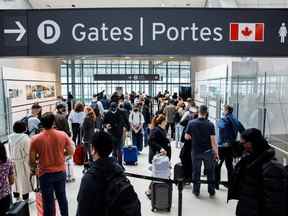 Les voyageurs se pressent dans la file d'attente de sécurité dans la salle des départs au début du long week-end de la fête de Victoria à l'aéroport international Pearson de Toronto à Mississauga le 20 mai 2022.