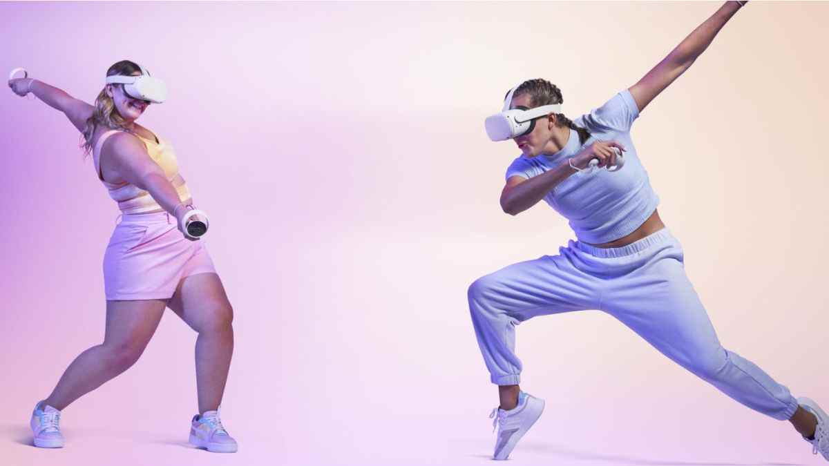 Two people dancing around using the Oculus Quest 2 on a pink gradient background