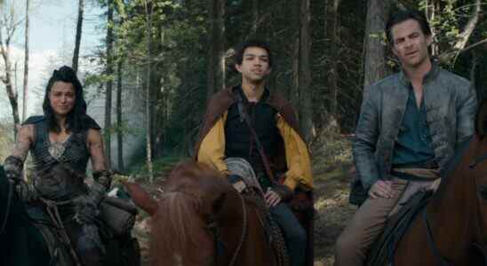 Michelle Rodriguez, Justice Smith, and Chris Pine having a conversation in the woods, on horseback in Dungeons & Dragons: Honor Among Thieves.