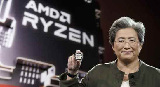 Dr. Lisa Su holding an AMD Ryzen 9 7950X CPU