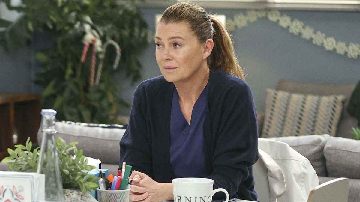 Meredith Grey sits at a desk on Grey