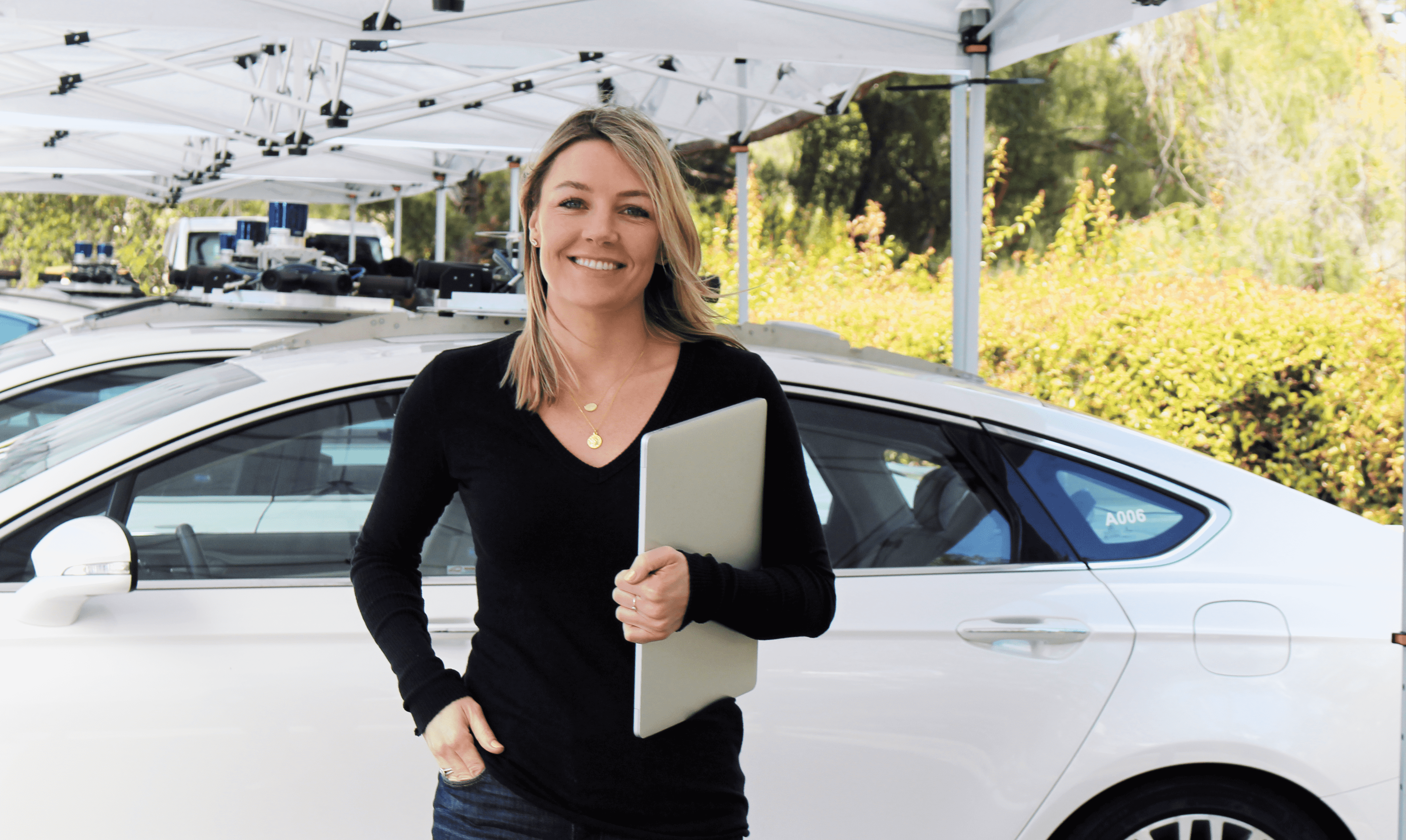 femme avec presse-papiers devant la voiture