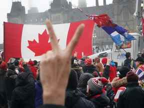 Les gens se rassemblent pour une manifestation organisée par des camionneurs opposés aux mandats de vaccination près de l'édifice du Parlement à Ottawa le 17 février 2022.